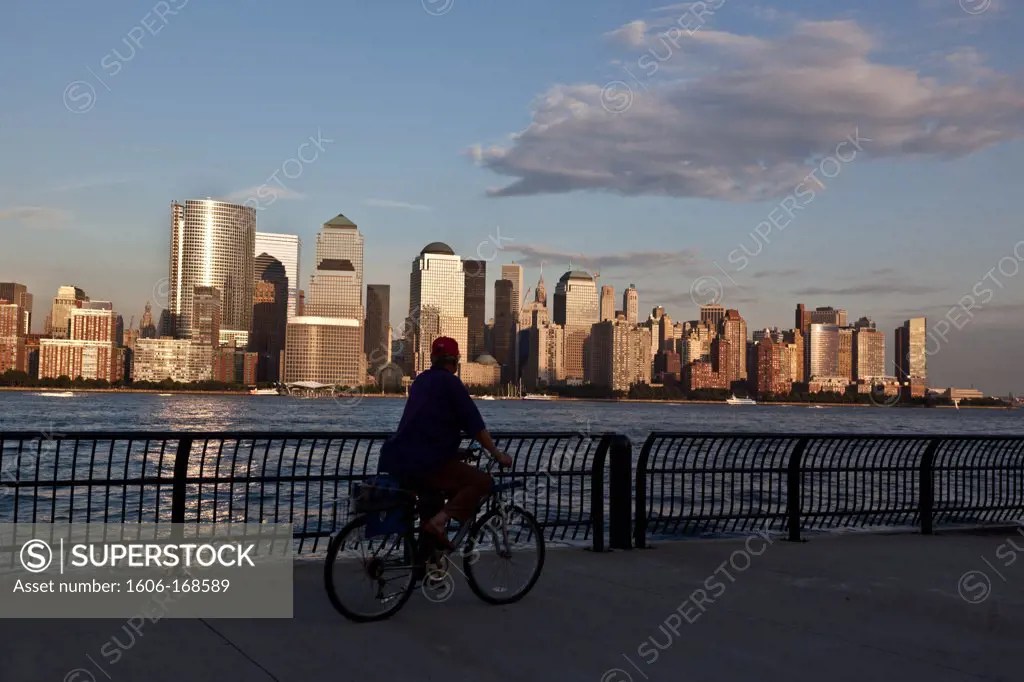 New York - United States, Downtown Manhattan cityscape, on Hudson river view from Grundy park exchange place New jersey , Manhattan skyline Midtown, Times square buildings, bike passing by
