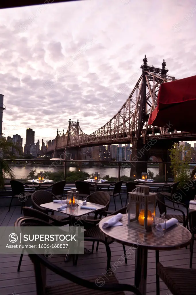 New York - United States, view on East river and the Queensboro bridge, from the Ravel Hotel rooftop terrace in Queens, sunset