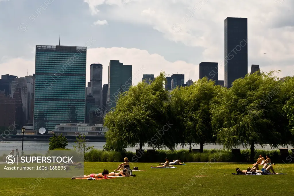 New York - United States, Queens, Long island city park, on the former Pepsi cola factory, in front of Manhattan skyline, people resting on the park