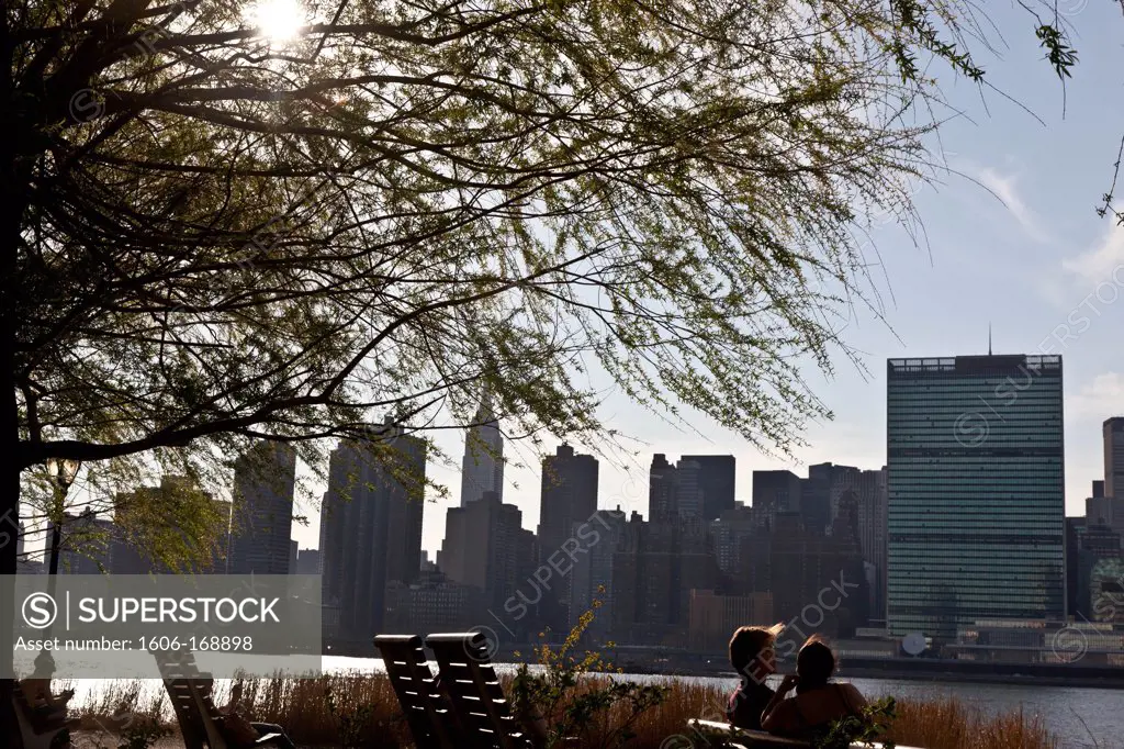 New York - United States, people gazing the view of Midtown Manhattan skyline from Gantry Plaza State park in Long island city, on the former Pepsi cola factory, Queens