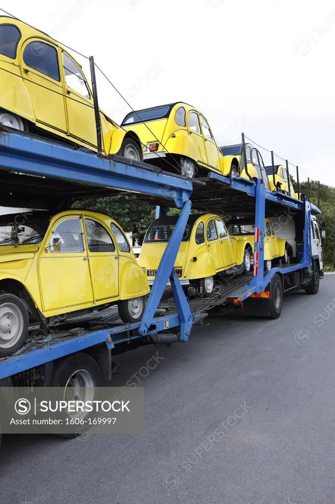 Several yellow 2CV on a truck