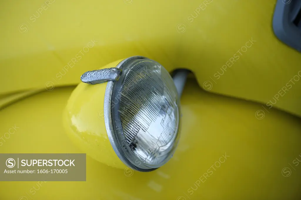 Detail of a yellow 2CV , headlight