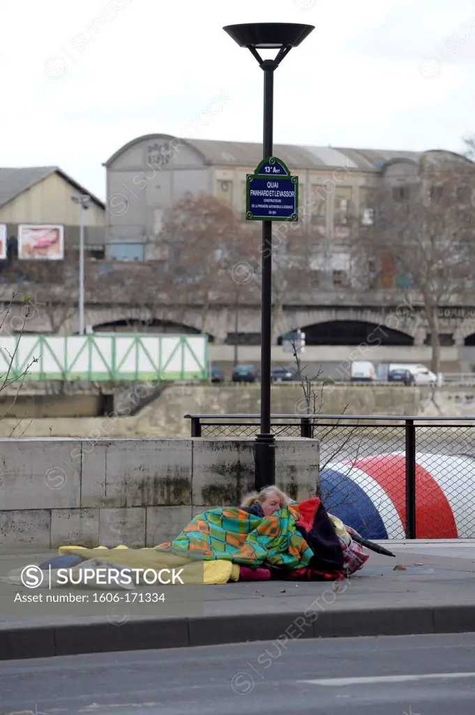 France, Paris, Homeless woman sleeping on the sidewalk
