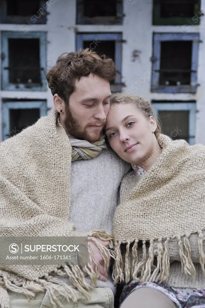 Young couple outside under a blanket