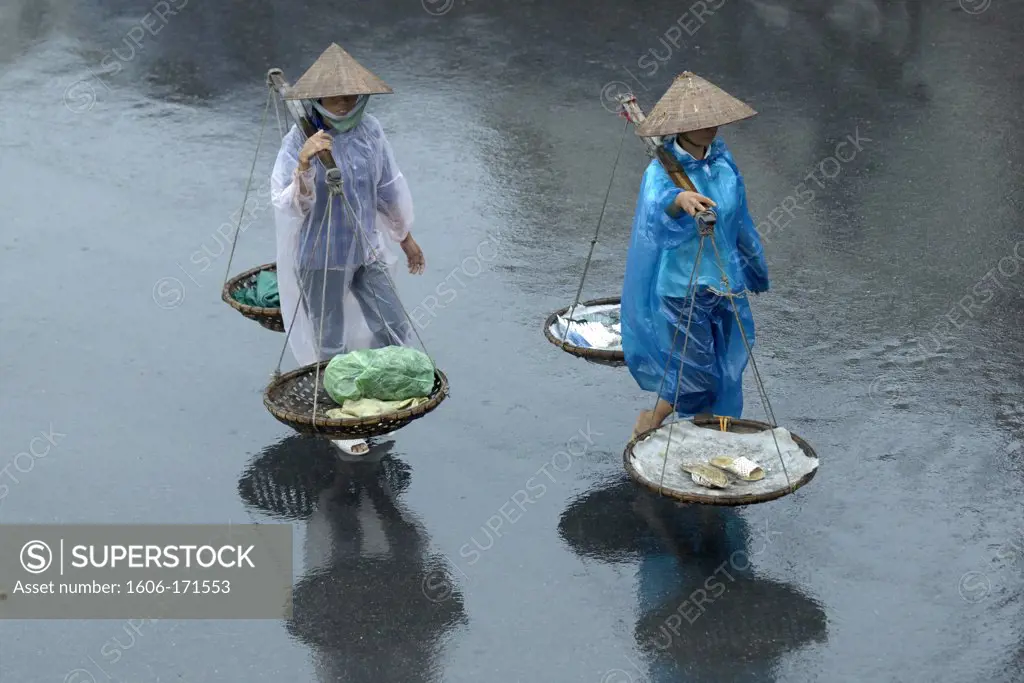 Asia, Southeast Asia, Vietnam, Hanoi, two women carrying yokes