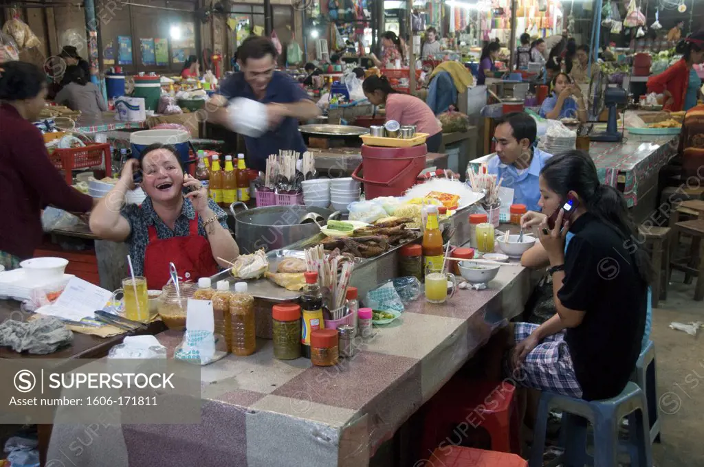 Asia; Cambodia; Siem Reap; the Old Market; (Phsar Chas) 2 women talking on mobiles,