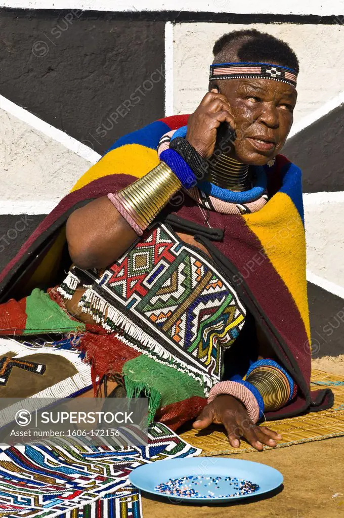 Africa, South Africa, Mpumalanga Province, KwaNdebele, Ndebele tribe, Mabhoko village, the artist Esther Mahlangu making a pearl carpet answering the phone