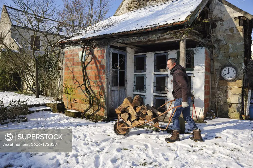 Man carrying firewood snowtime