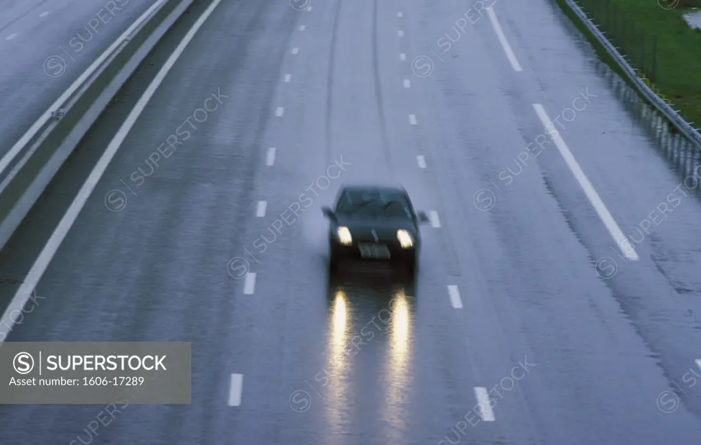 Car on empty motorway, rain, blurred effect