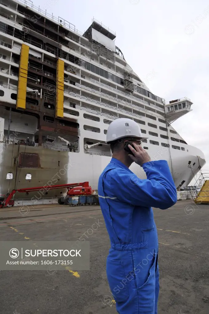 France, Saint Nazaire, STX Europe shipyards, ship MSC Divina under construction, worker talking on the phone