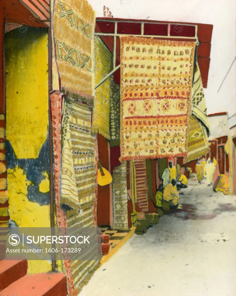 Painted photograph of street of a carpets souk in Morocco on barite photographic paper