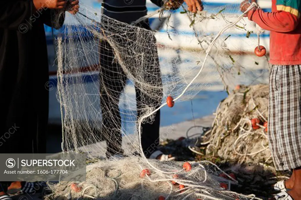 Djerba fishermen tending nets Houmt Souk. Tunisia.