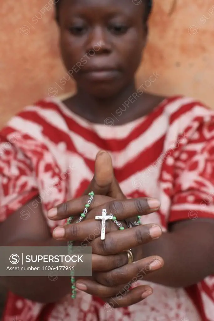 African woman praying the rosary. Lome. Togo.