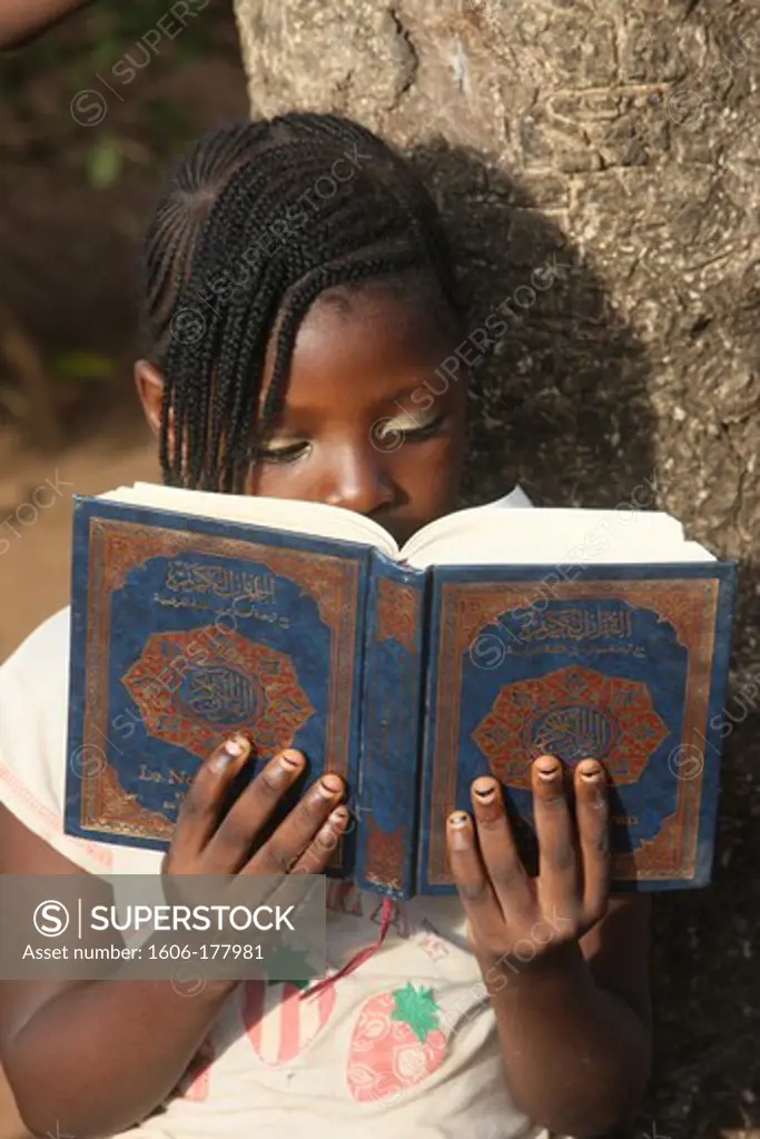 Young girl reading the koran. Lome. Togo.
