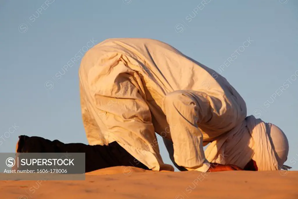Beduin praying in the Sahara Douz. Tunisia.