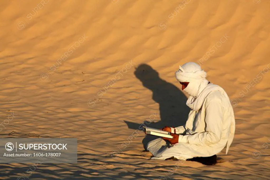Beduin reading the Kuran in the Sahara Douz. Tunisia.