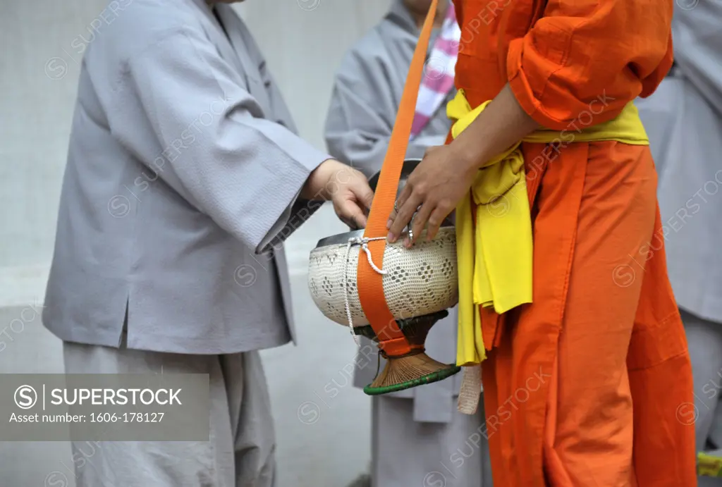 Asia, Southeast Asia, Laos, Luang Prabang, Novice monks begging for food, close up of bowl