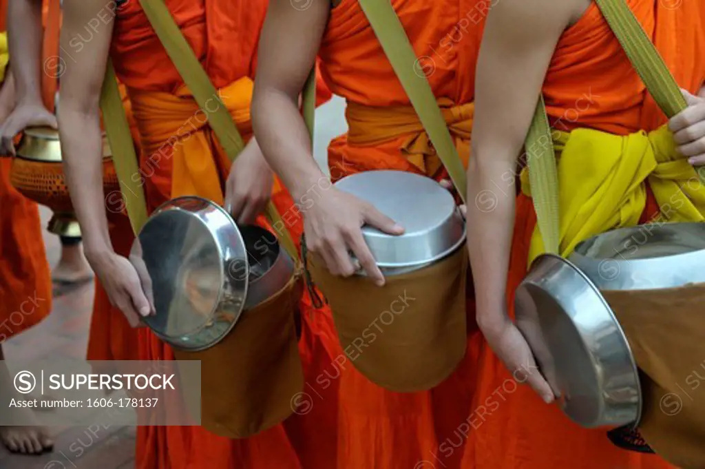 Asia, Southeast Asia, Laos, Luang Prabang, Novice monks begging for food, close up of the bowls