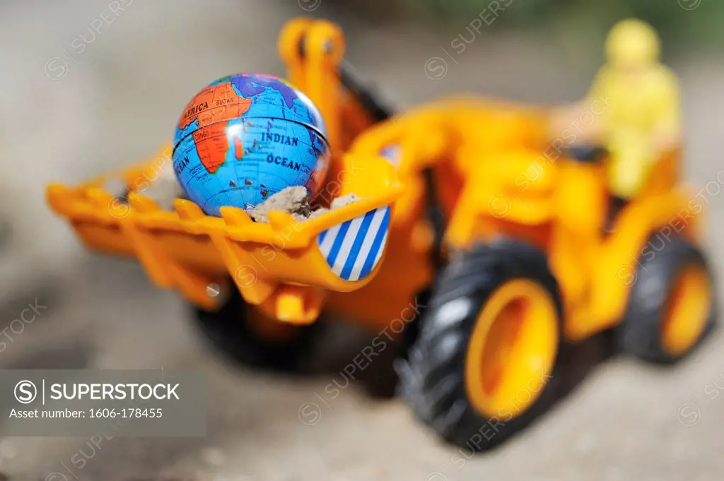 Bulldozer carrying a world globe