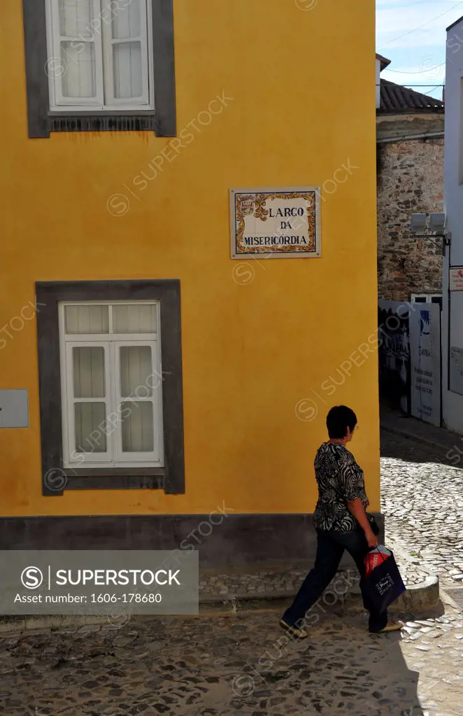 Woman walking in a street of Tavira,Portugal,South Europa,Europa