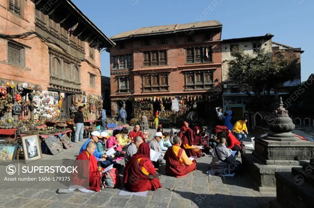 Nepal Katmandu group of tibetan monks praying in Swayambhu temple