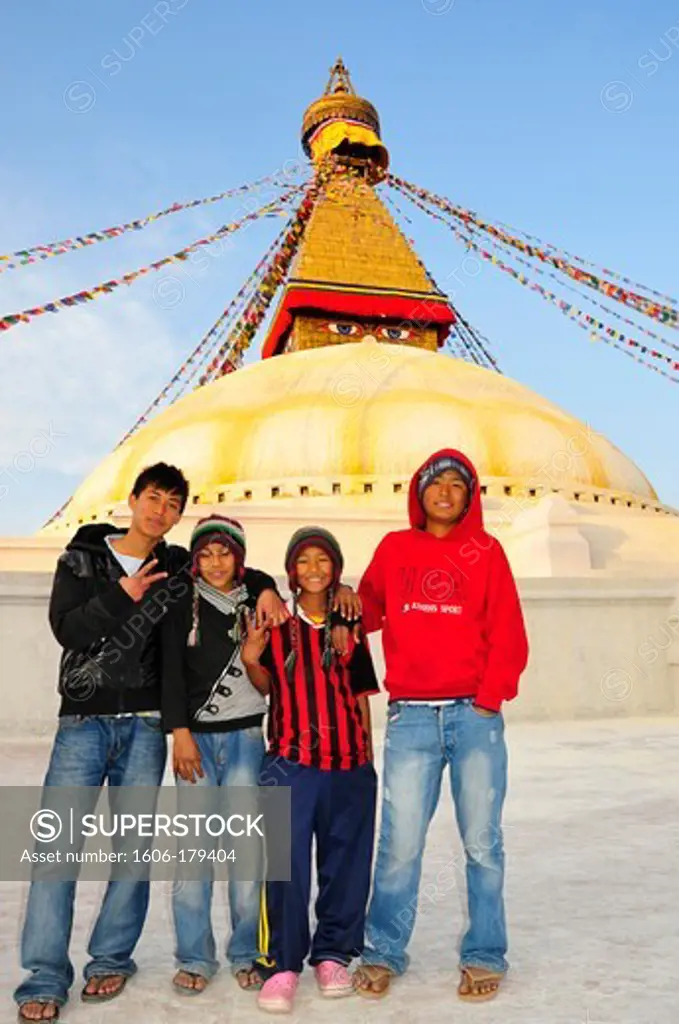 Nepal Kathmandu nepalese teenagers take a pose in front of the stupa of BODNATH the biggest stupa in the world