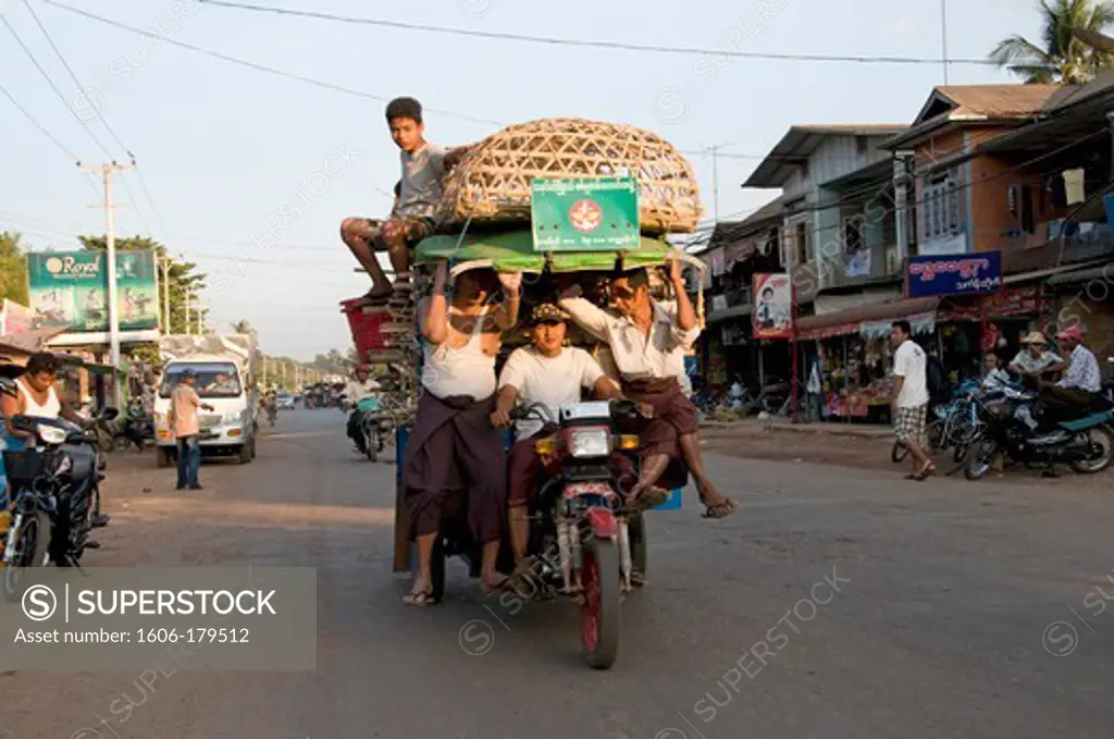 Burma BAGO a group of men are perched on a motorcycle over loaded
