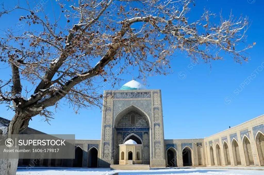 UZBEKISTAN BUKHARA view of the interior courtyard of the  KALON mosque with its cupola and MIHRAB under the snow