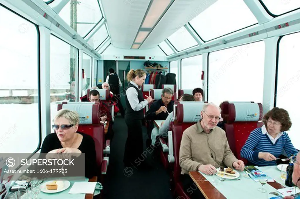 Europe, Switzerland, Alpes mountains, Grisons Province (GR), inside the Glacier Express train, passengers talk with the waitress Margarida Gonzales working on board since 5 years