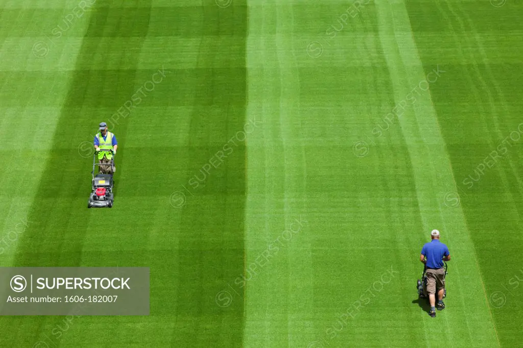 Republic of Ireland,Dublin,Greenkeepers Mowing Playing Field in The Aviva Stadium