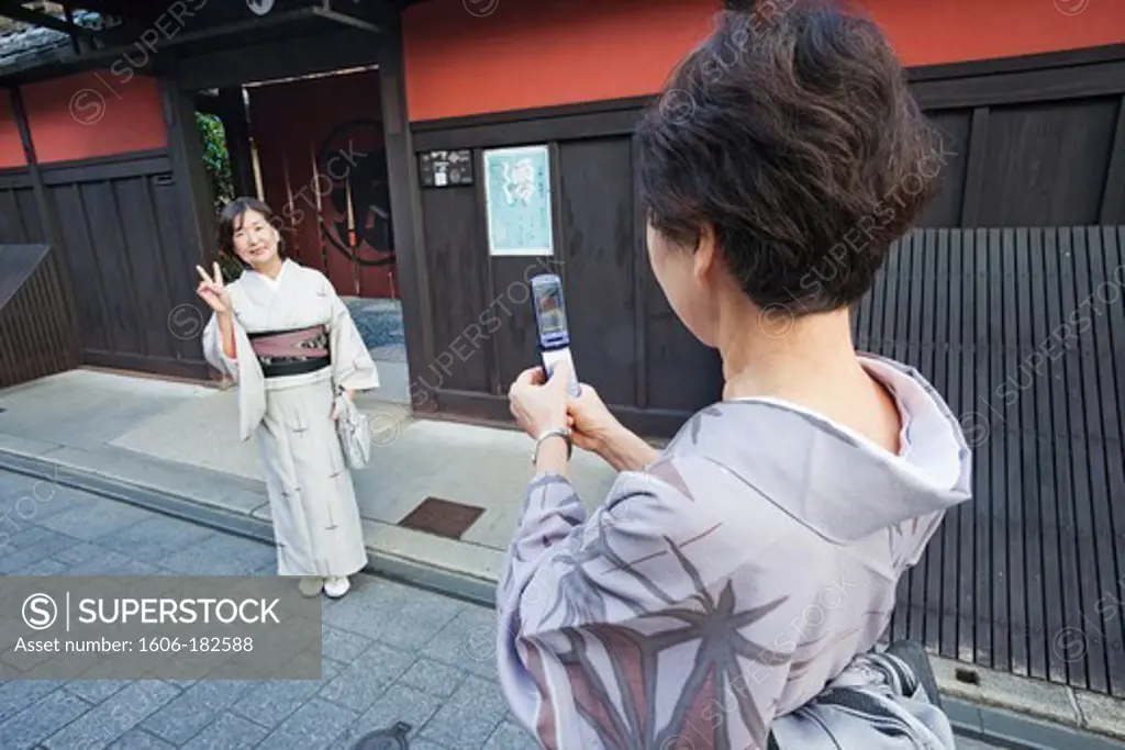 Japan,Kyoto,Higashiyama,Women in Kimono Taking Photos on Mobile Phone