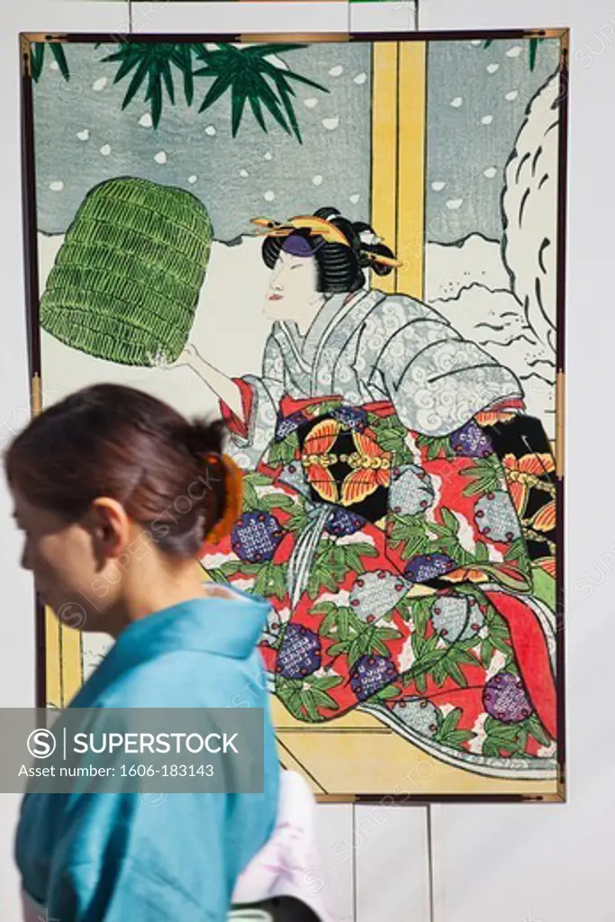 Japan,Tokyo,Ginza,Woman Walking Past Kabuki Advertising Posters