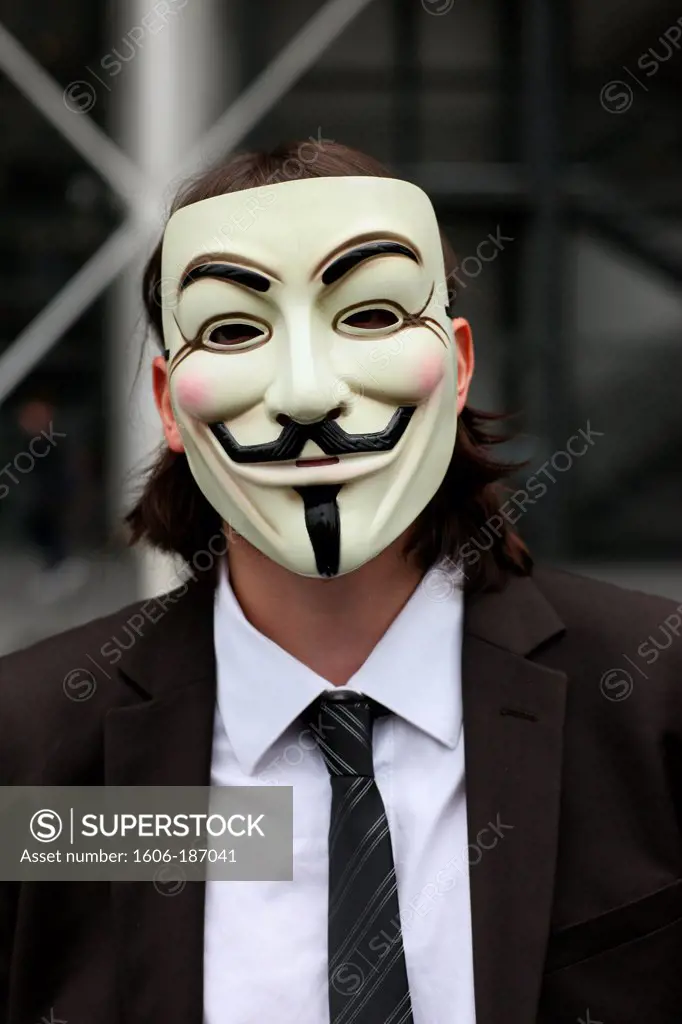 Protester wearing a Guy Fawkes mask , trademark of the Anonymous movement and based on a character in the film V for Vendetta. Paris. France.