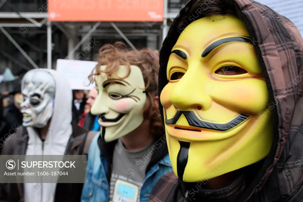 Protesters wearing Guy Fawkes masks , trademark of the Anonymous movement and based on a character in the film V for Vendetta. Paris. France.