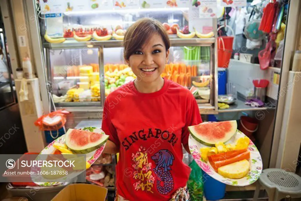 Singapore,Waitress Serving Fruit in Typical Hawker Center Food Court
