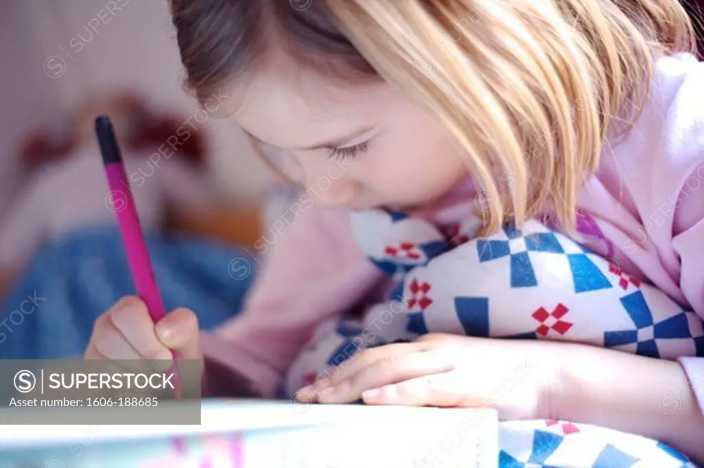 6-year-old girl, drawing in her bed