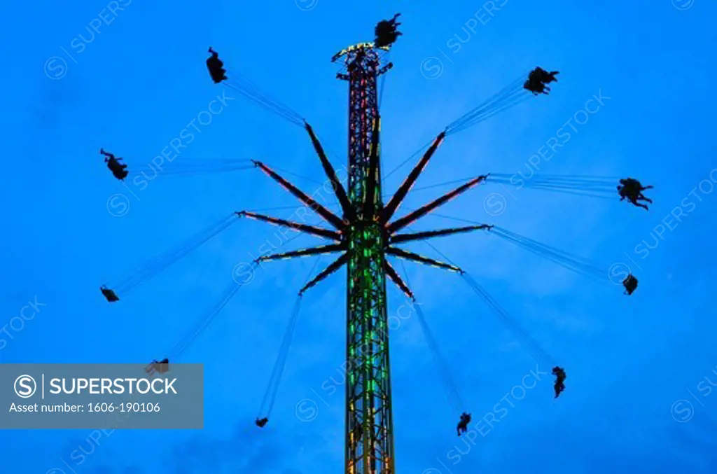 People having fun on a chair carousel in Foire du Trône brings country fair attractions and amusements to Paris in the 12 th arrondissement,France,Europe