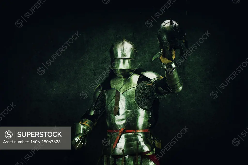 Portrait of a Knight after the battle, an enemy helmet in his hand