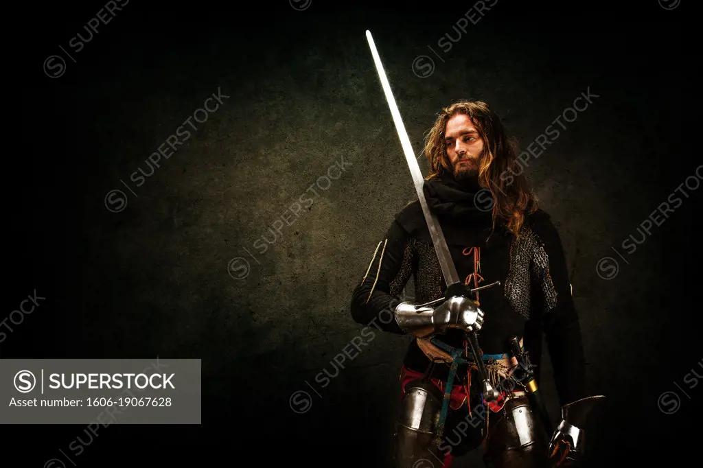 Portrait of a Knight "on guard" in studio on black background.