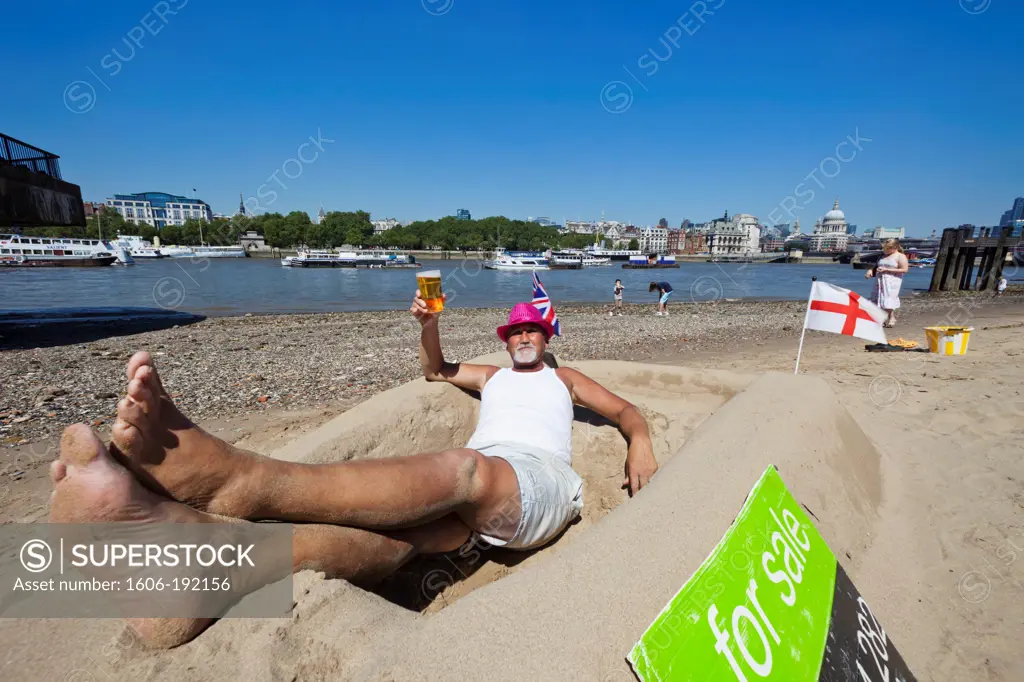 England,London,Bankside,Sand Sculpture Artist Relaxing on Bank of River Thames