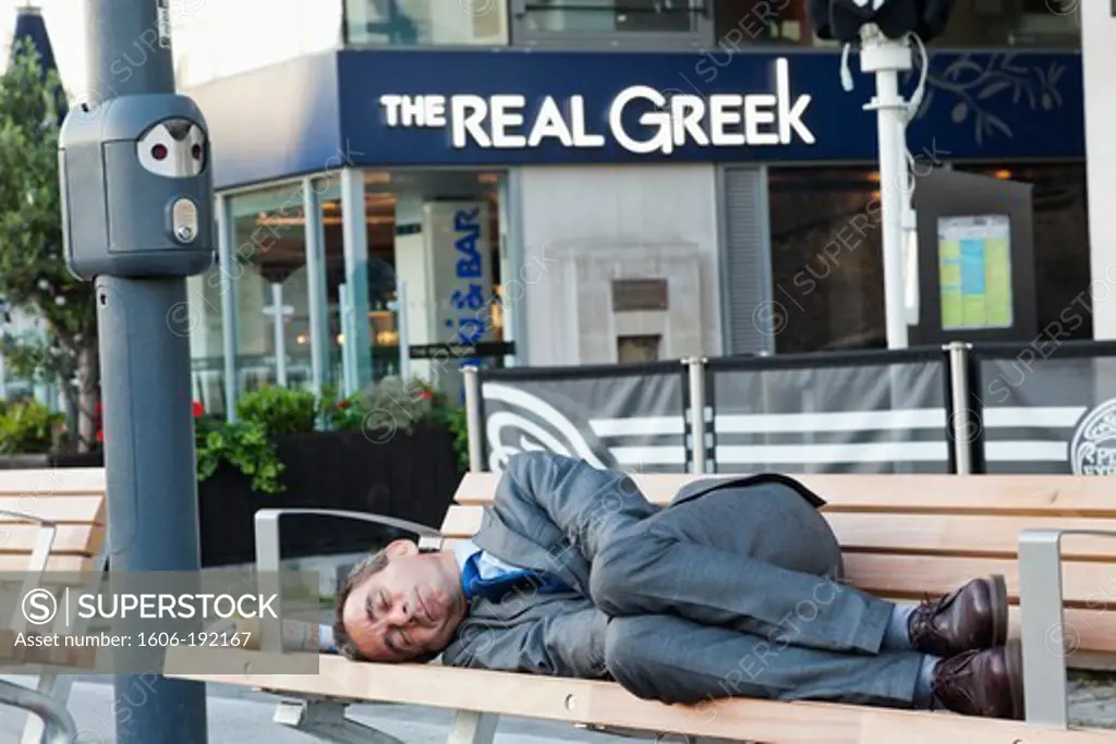 England,London,Bankside,Man Sleeping in front of Restaurants