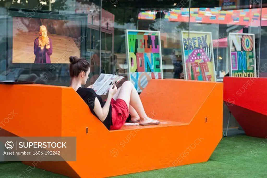 England,London,Southwark,South Bank,Southbank Centre,Girl Relaxing in front of The National Theatre