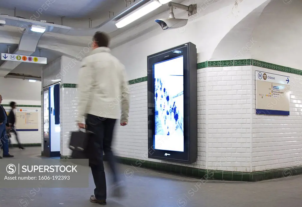 France, Paris, Man Passing In Front Of An Advertising Video Panel In The Metro