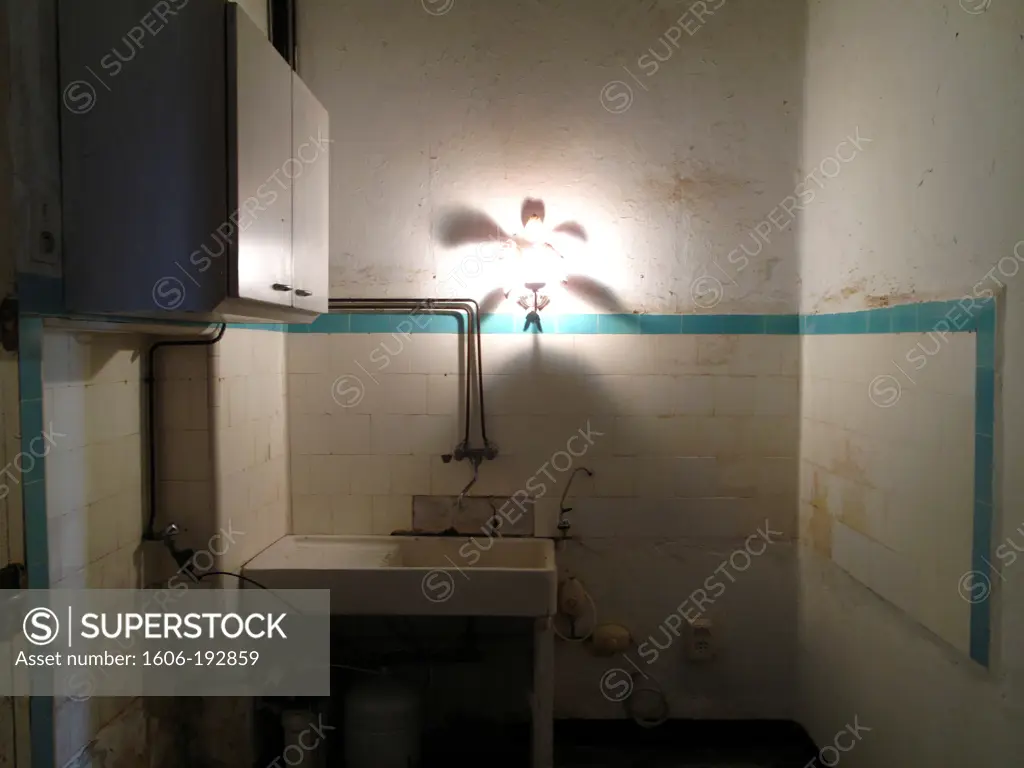Dilapidated Kitchen With Cupboard And Dirty Sink