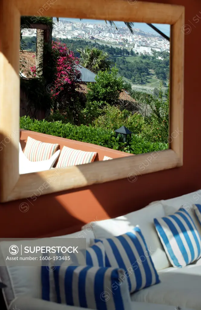 Morocco, Tangier, View Of Sofa With Striped Cushions Above Which A Mirror Reflects The Landscape