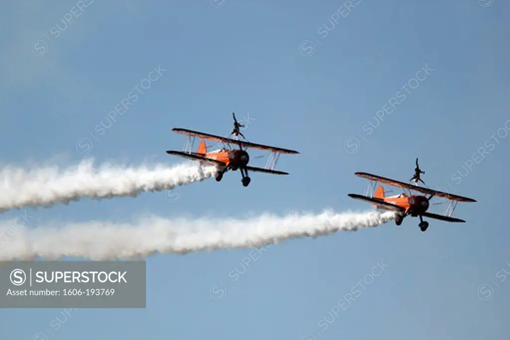 France, Essonne, La Ferte Alais, Airshow 2012. Wing Walkers On Stearman Aircraft In Full Aerobatics.