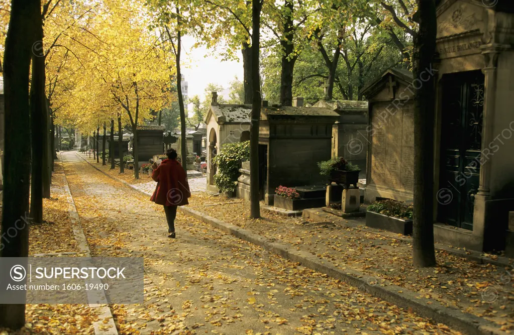 France, Paris, Pere-Lachaise cemetery, woman wlaking in side path