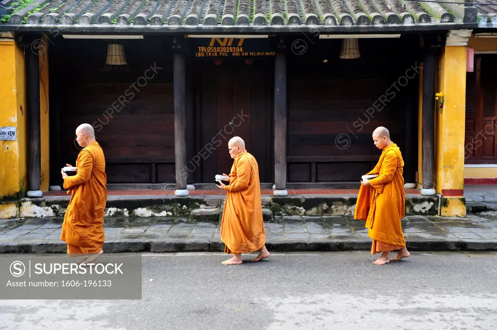 A Group Of Monks Are Walking In A Street Of Hoi An To Receive The Food Offering, Vietnam, South East Asia, Asia