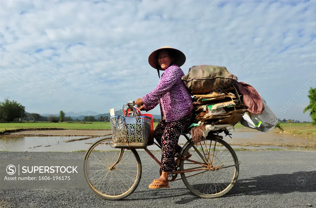 A Cyclist On A Rural Street In Vietnam'S Central Highlands, Vietnam, South East Asia, Asia