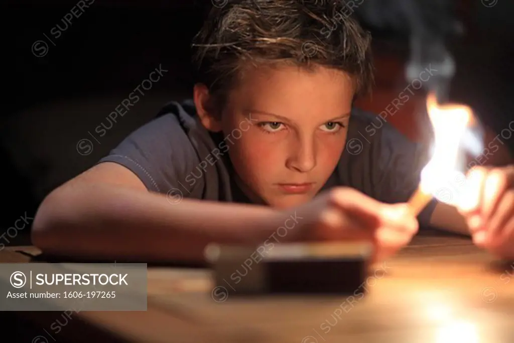 France, Young Boy And Fire